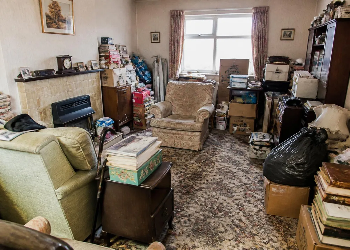 Cluttered room with years of belongings — the type of property we regularly clear